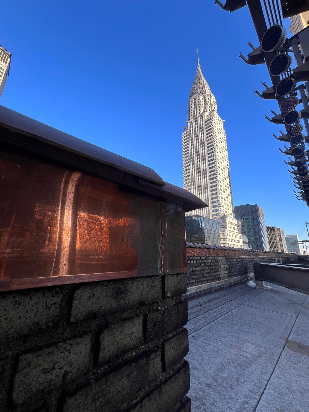 Copper roof detail on a New York City rooftop with the Chrysler Building beyond